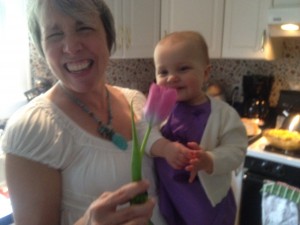 Coleen with Claire smelling flowers