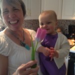 Coleen with Claire smelling flowers